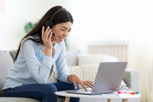 asian-woman-studying-foreign-languages-online-with-laptop-and-headset-at-home.jpg